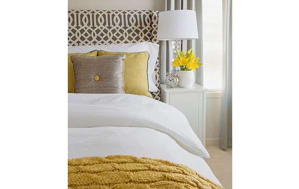 bed with yellow throw blanket